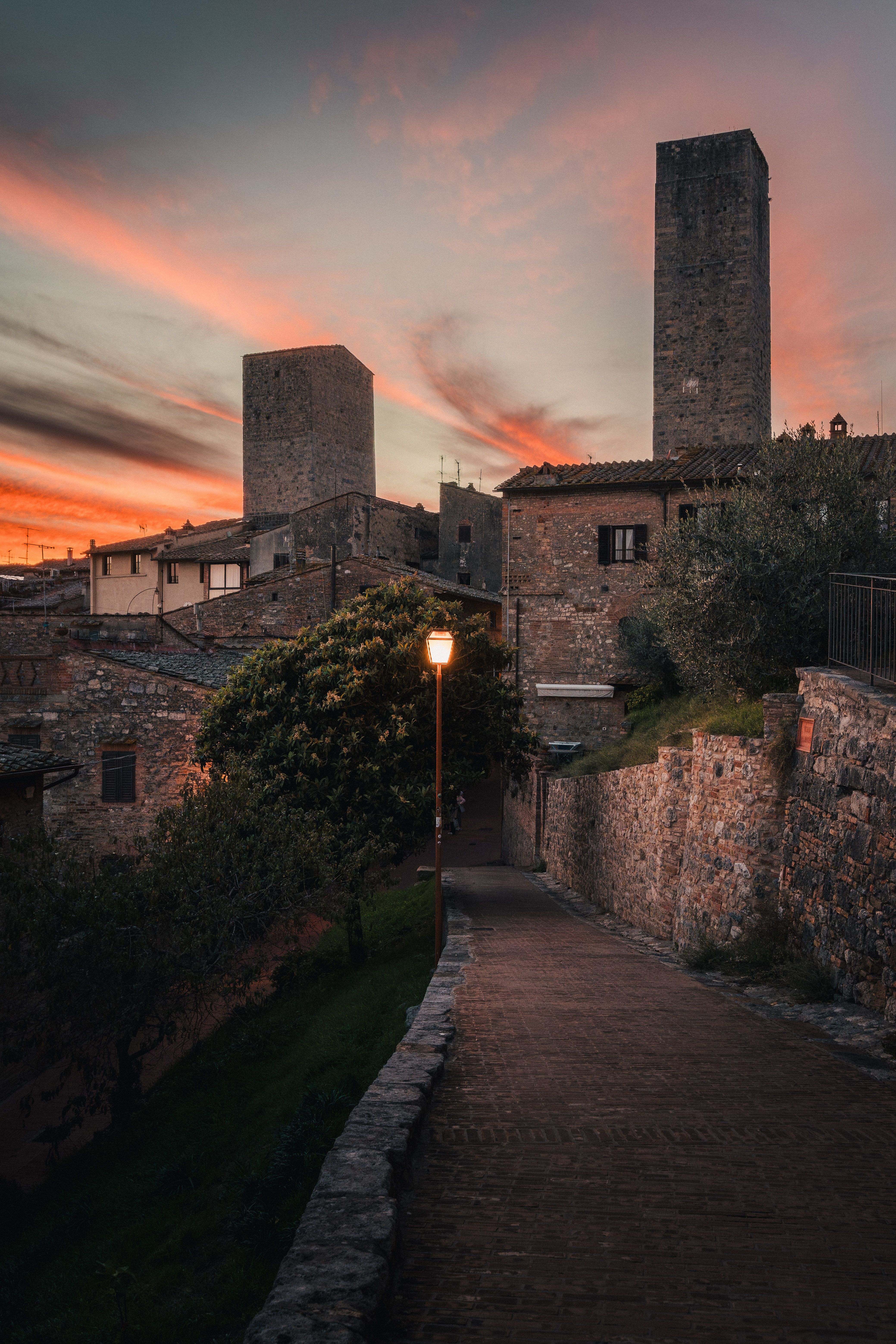 Brick walkway through Tuscany at sunset.